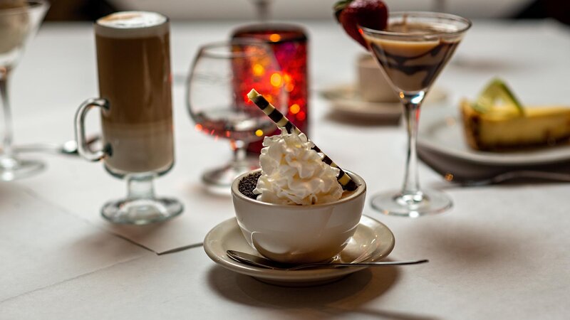 Coffee topped with whipped cream and cookie